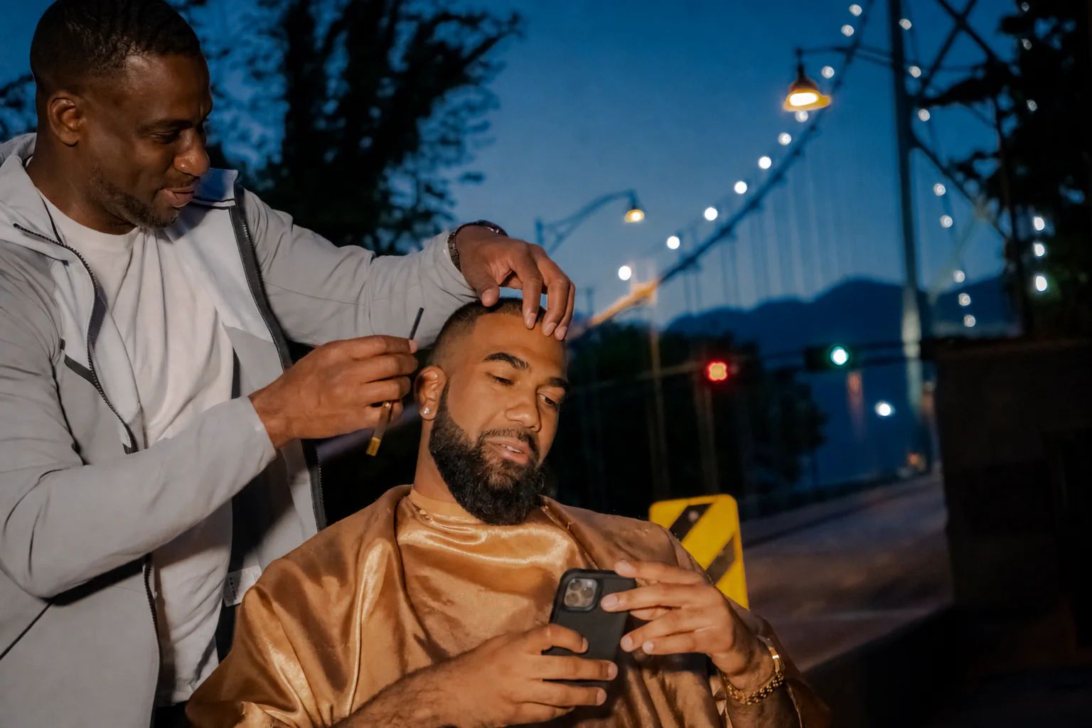 Junior carefully shaping a client’s hairline